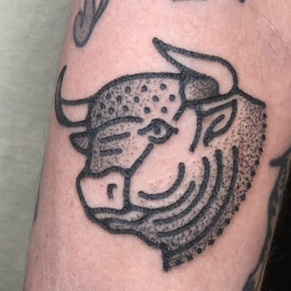 Hand-poked tattoo by Adam Sage, featuring smooth, precise linework and strong graphic composition. Inspired by brutalist architecture, children’s book illustration, and Soviet poster design, Adam creates timeless, non-electric tattoos with bold, simple forms.