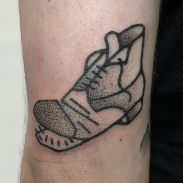 Hand-poked tattoo by Adam Sage, featuring smooth, precise linework and strong graphic composition. Inspired by brutalist architecture, children’s book illustration, and Soviet poster design, Adam creates timeless, non-electric tattoos with bold, simple forms.