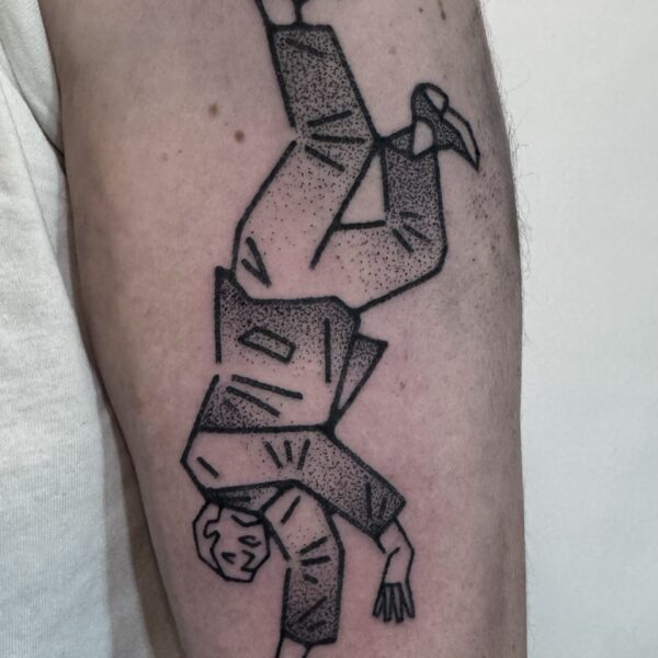 Hand-poked tattoo by Adam Sage, featuring smooth, precise linework and strong graphic composition. Inspired by brutalist architecture, children’s book illustration, and Soviet poster design, Adam creates timeless, non-electric tattoos with bold, simple forms.