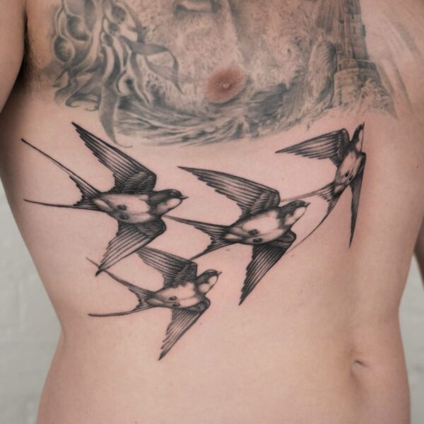 A group of realistic swallows tattooed by Alex Rufio. Alex is based in both Brighton, and London.