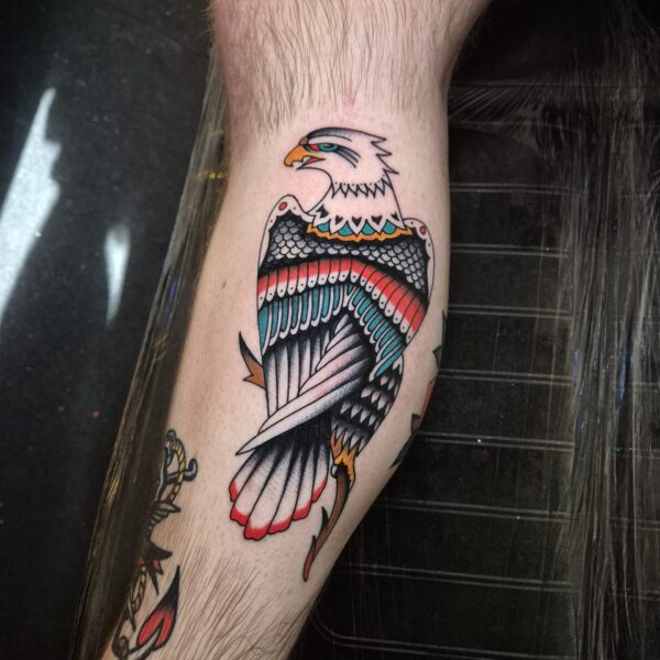 Traditional style eagle tattoo by Edoardo Cucchelli. With over ten years experience tattooing, Edoardos practice is focused within the European traditional style, creating bright, bold, colorful tattoos for his clientele.