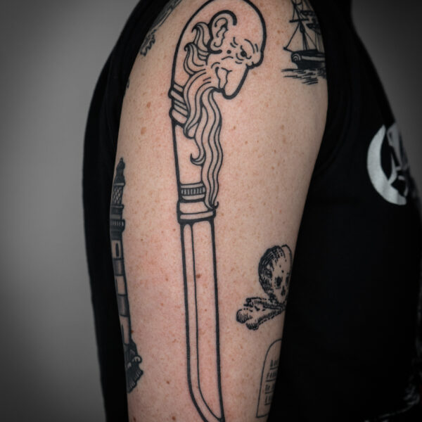 Intricate tattoo by Mouse, inspired by medieval woodcut illustration and folklore. The design features detailed, hand-drawn linework blending magical and mythical imagery with surreal and playful elements. Mouse works between London and Brighton, creating storytelling tattoos with bold, meticulous detail.