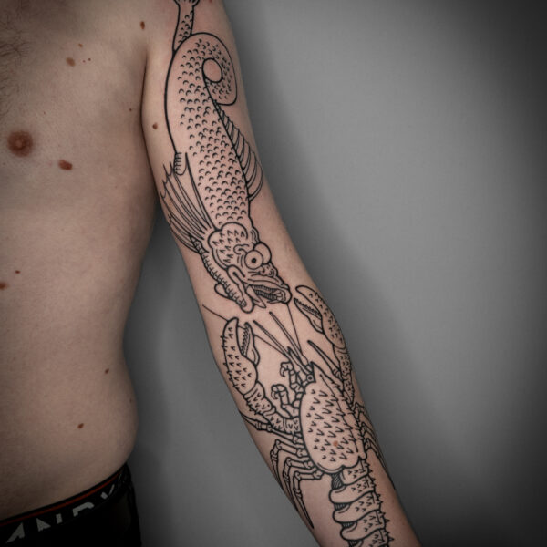 Mouse is an artist based at Nowhere Tattoo Shop in Brighton, East Sussex. Mouse has built a reputation by creating fanciful, and quirky tattoos, often depicting off-beat subjects, such as, frogs dancing around a fire, men with berries on their heads, hands appearing from clouds, and rabbits riding snails.