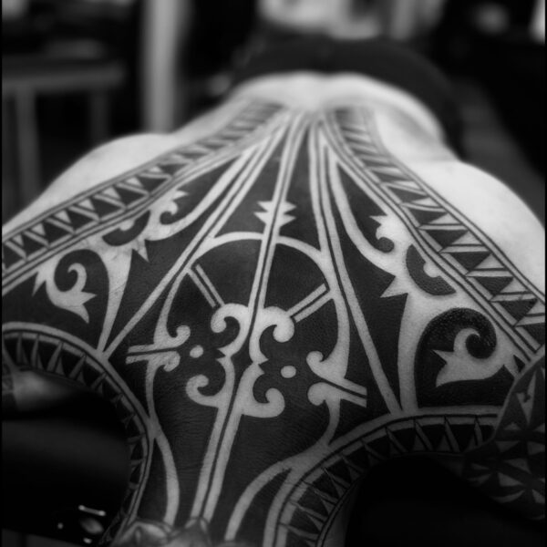 Bold blackwork tattoo by Francesco Capro, featuring strong ornamental patterns and timeless design. Francesco, originally from Northern Italy, works from Nowhere Tattooing in Brighton and Seven Doors Tattoo in London, bringing over thirteen years of experience and a passion for powerful, culturally rich tattoo art.